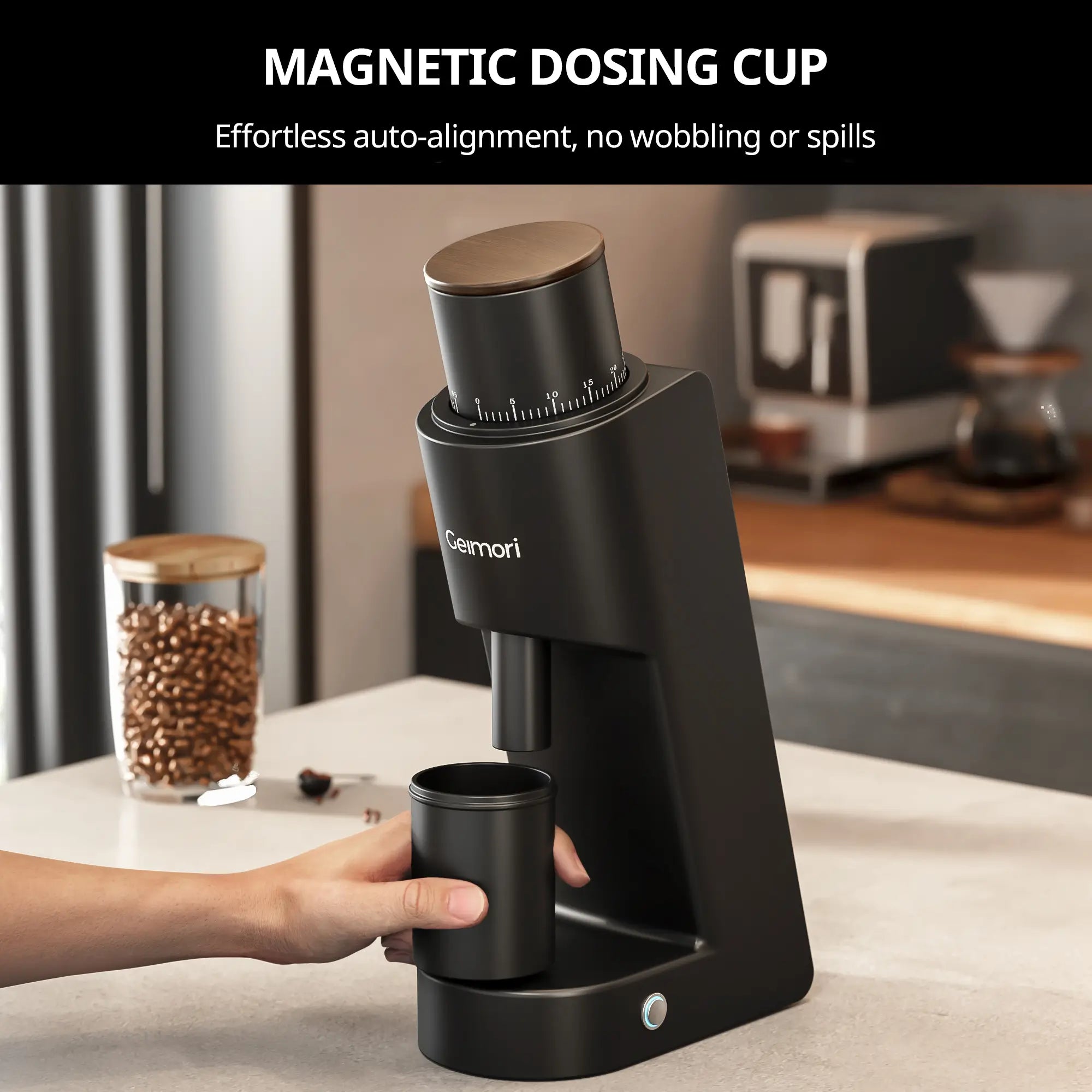 A black magnetic dosing cup by Geimori GU38 on a kitchen counter, with a hand holding the cup under the dispensing mechanism. The background shows a blurred coffee setup, and a black banner at the top reads 'MAGNETIC DOSING CUP' with descriptive text.