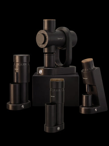 A set of black optical instruments and accessories from Demetol, including eyepieces, collimators, and stands, arranged on a black background.