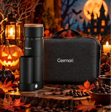 A Geimori coffee grinder and matching carrying case displayed together in a Halloween-themed setting with pumpkins, candles, autumn leaves, and a haunted-house background.